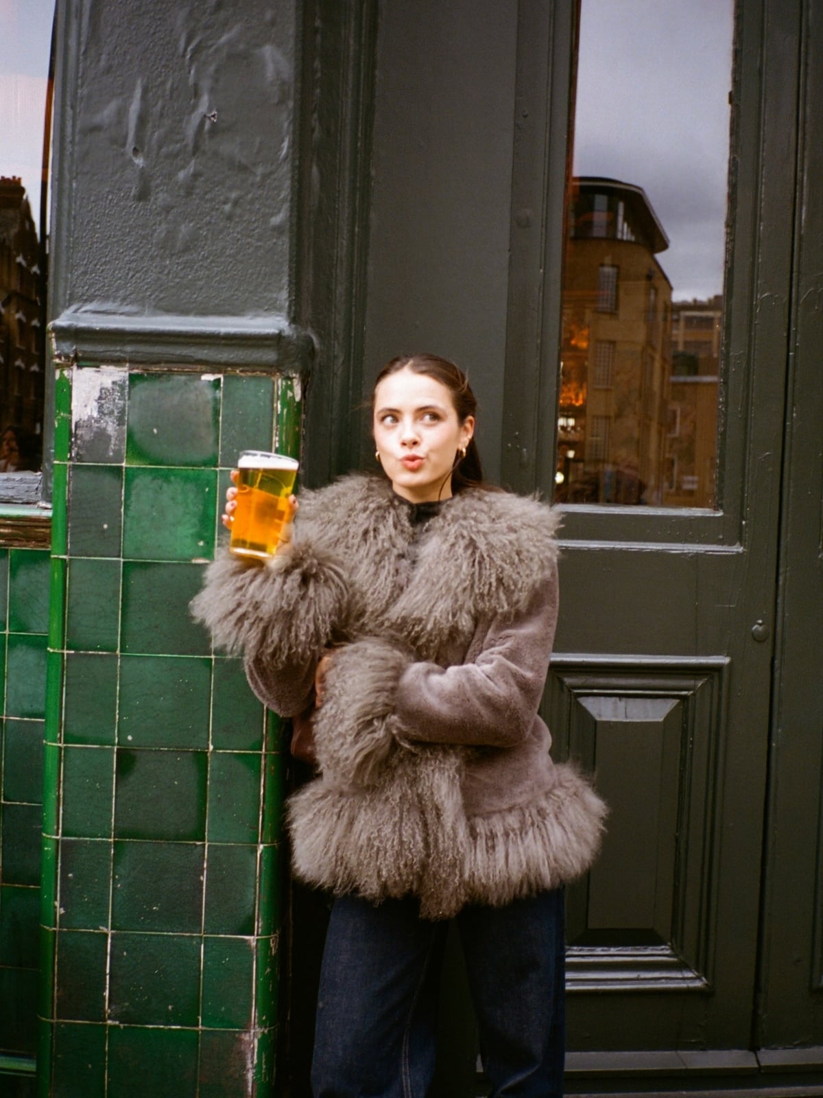Gray Faux Fur Coat Over a Black Top and Straight Leg Jeans — Brewery Outfits