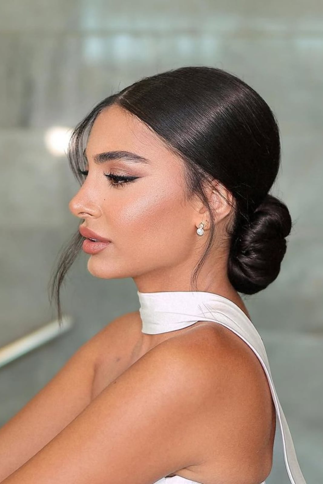 Dark Brown Sleek Low Bun With Wispy Pieces Dark Brown Sleek Low Bun With Wispy Pieces — Bridesmaid Hair