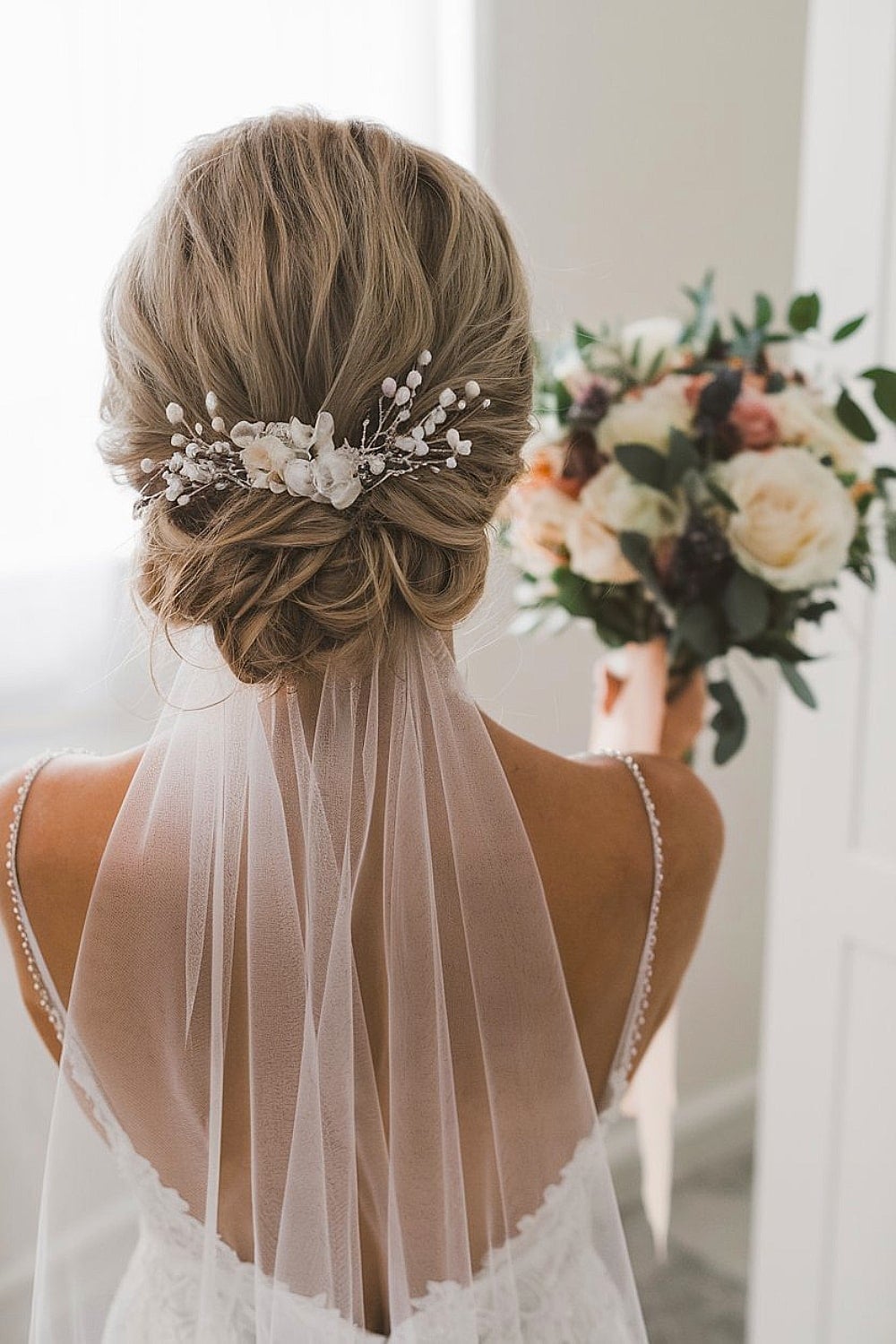 Blonde Twisted Updo With Pearls and Flowers Blonde Twisted Updo With Pearls and Flowers — Bridesmaid Hair
