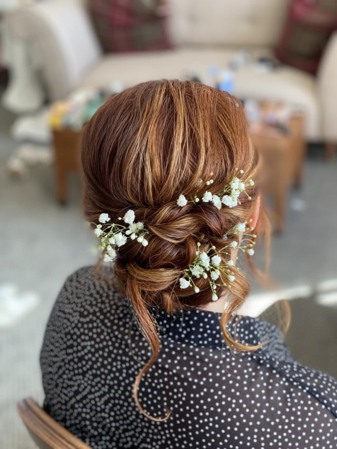 Reddish Brown Braided Bun With Floral Accents Reddish Brown Braided Bun With Floral Accents — Bridesmaid Hair