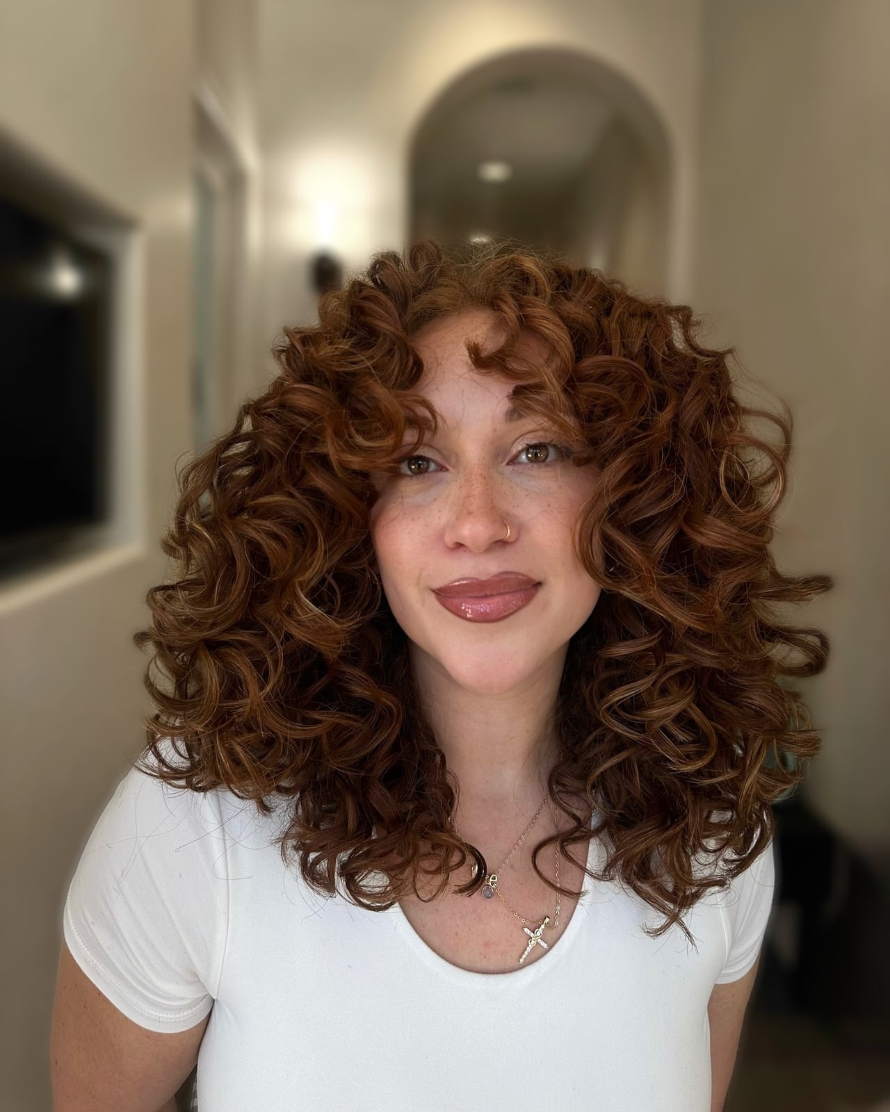 Collarbone Medium Brown Curls With Caramel and Curtain Bangs — Brown Curly Hair