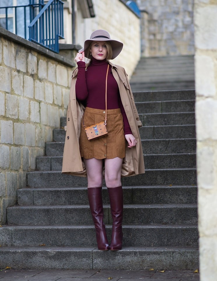 Burgundy Boots with Trench Coat and Mini Skirt and Tan Wide-Brim Hat — Burgundy Boots Outfit