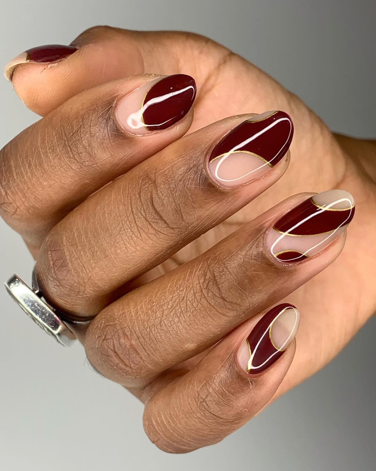Medium Oval Nails With Abstract Burgundy Lines — Burgundy Nails Art