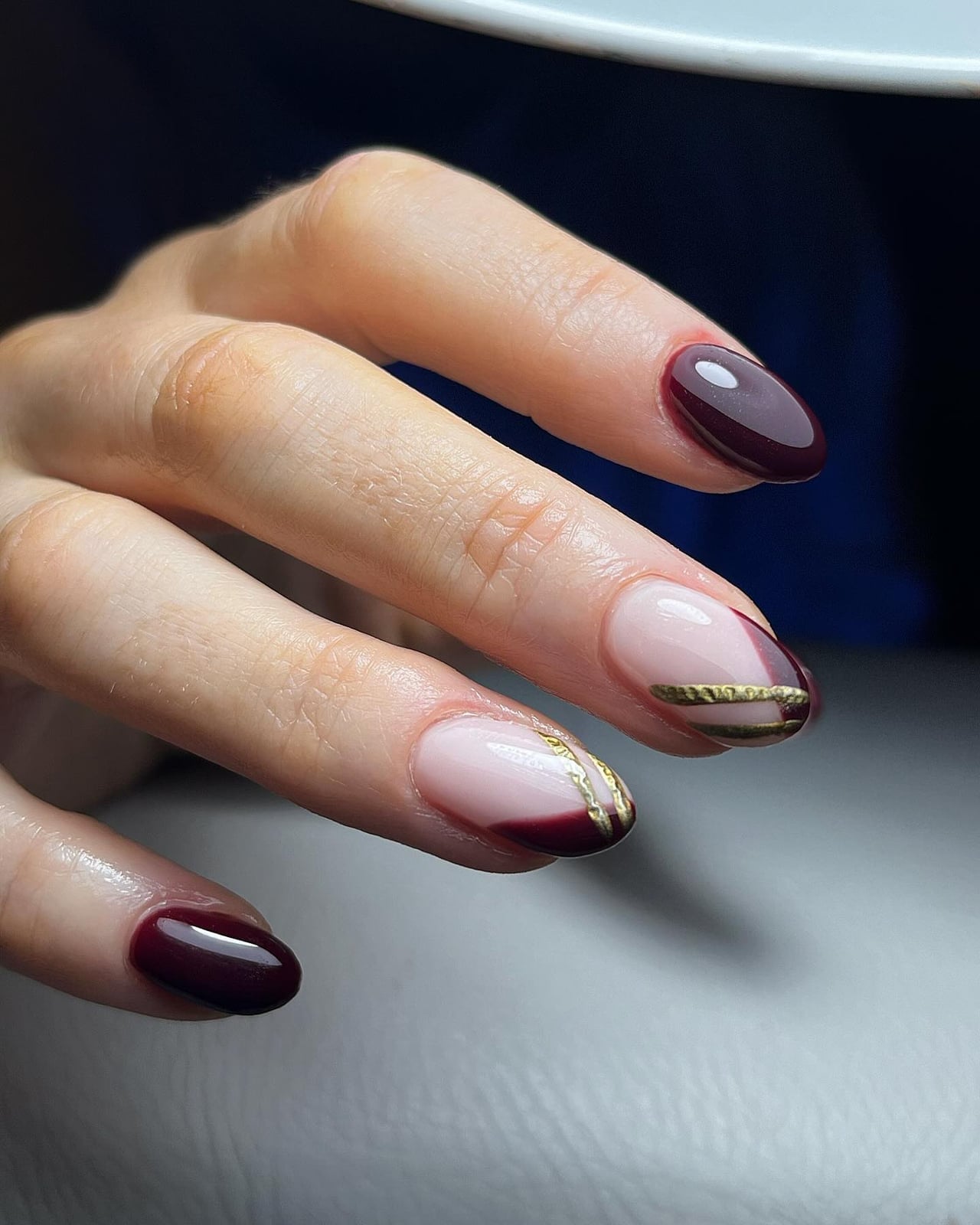 Short Oval Nails With Gold Stripe Accents — Burgundy Nails Art