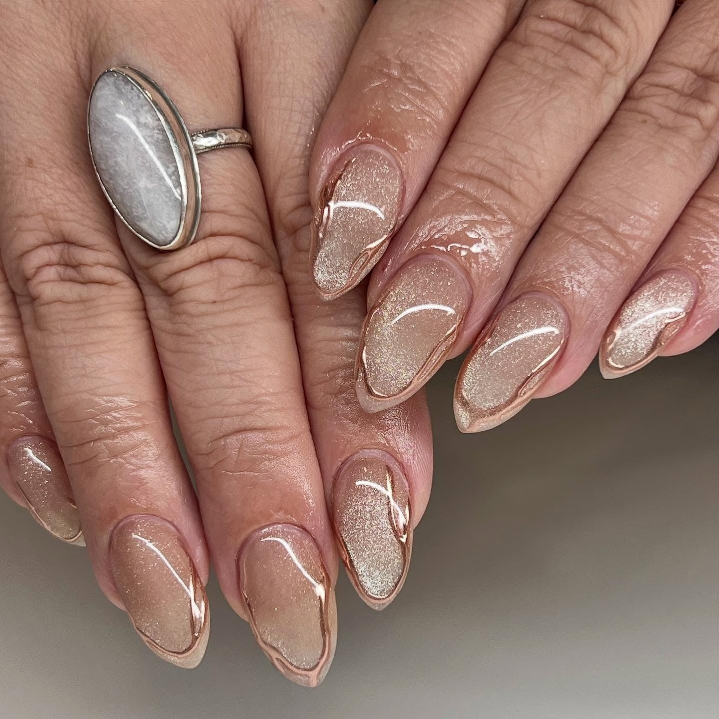 Sheer Beige Satin Gold Line Medium Stiletto Almond, Close-Up Take Sheer Beige Satin Gold Line Medium Stiletto Almond, Close-Up Take — Champagne Nails