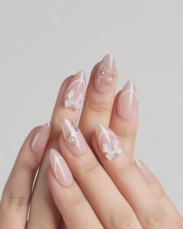 Sheer Pink Nude Glitter Glossy Medium Almond Nails with Bows Sheer Pink Nude Glitter Glossy Medium Almond Nails with Bows — Champagne Nails