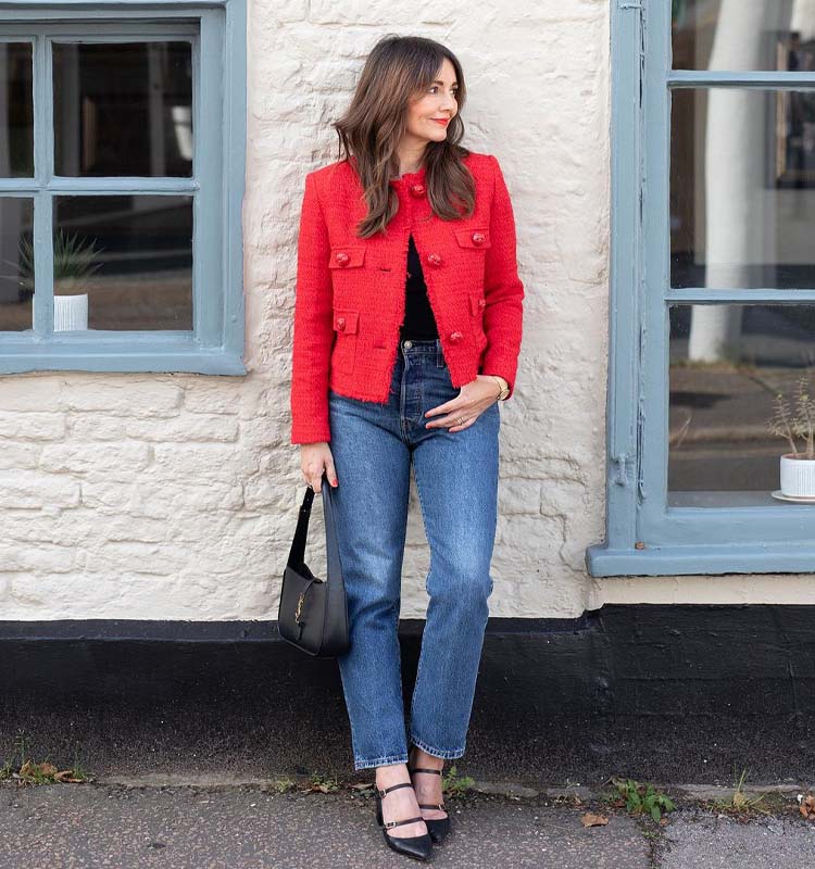 Red Tweed Jacket Over Black Top And Blue Jeans — Christmas Party Outfits Casual