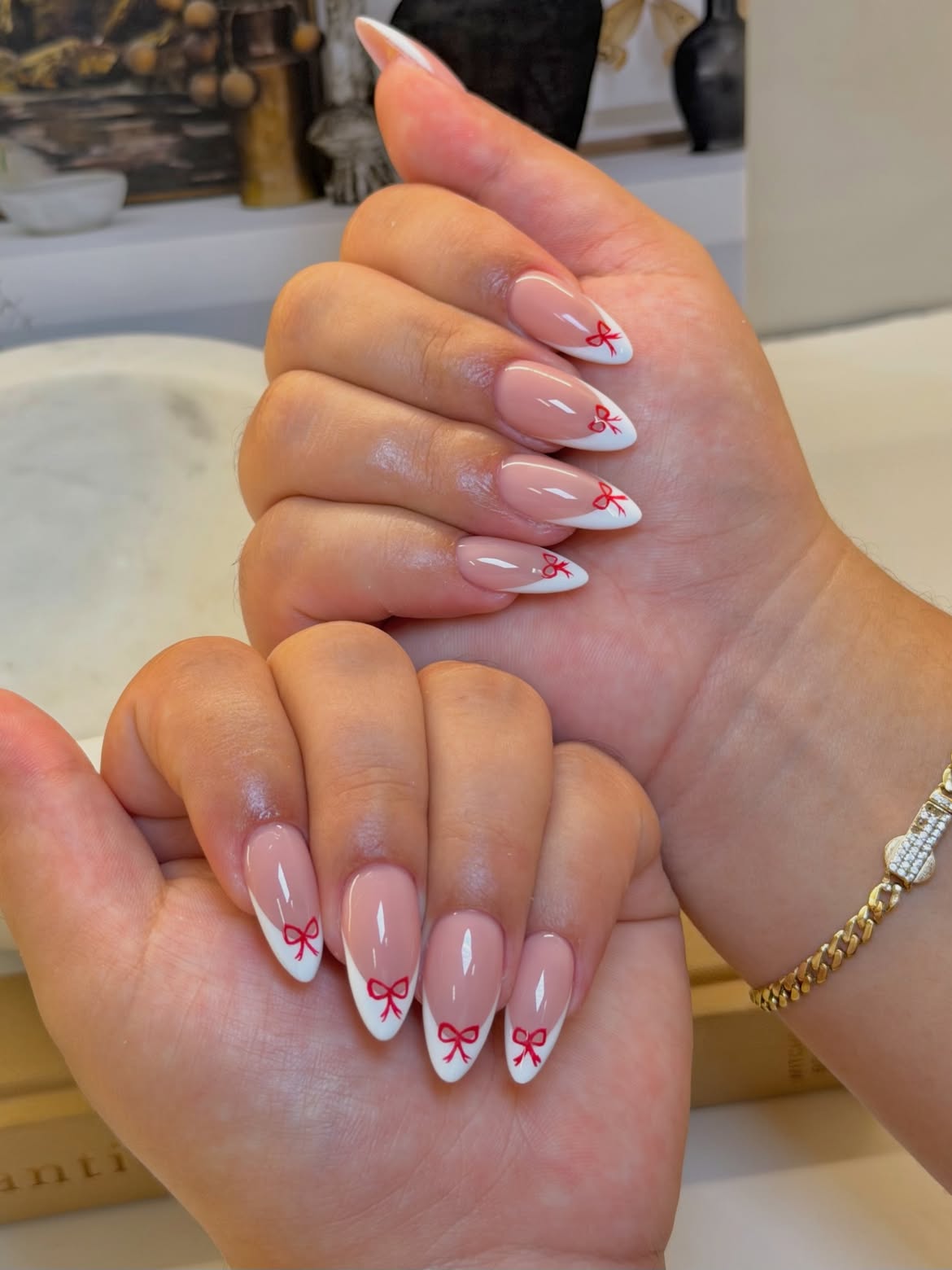 Classic French Almond Nails with Red Bow Accents