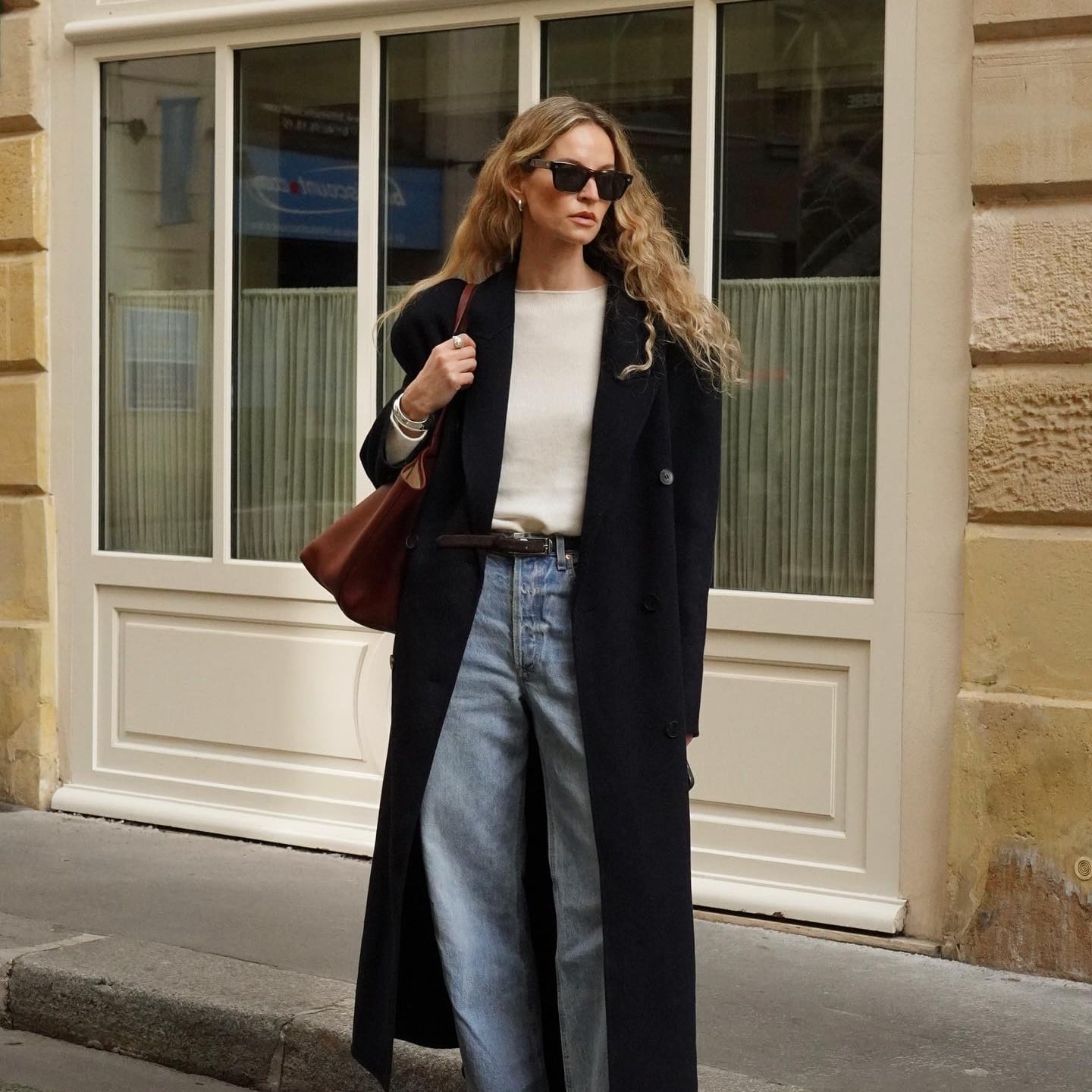 Long Black Coat Over Cream Sweater and Light Blue Jeans — Classy Outfits