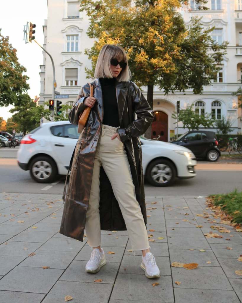 Vinyl Trench Coat Over Black Turtleneck and Cream Trousers — Classy Outfits