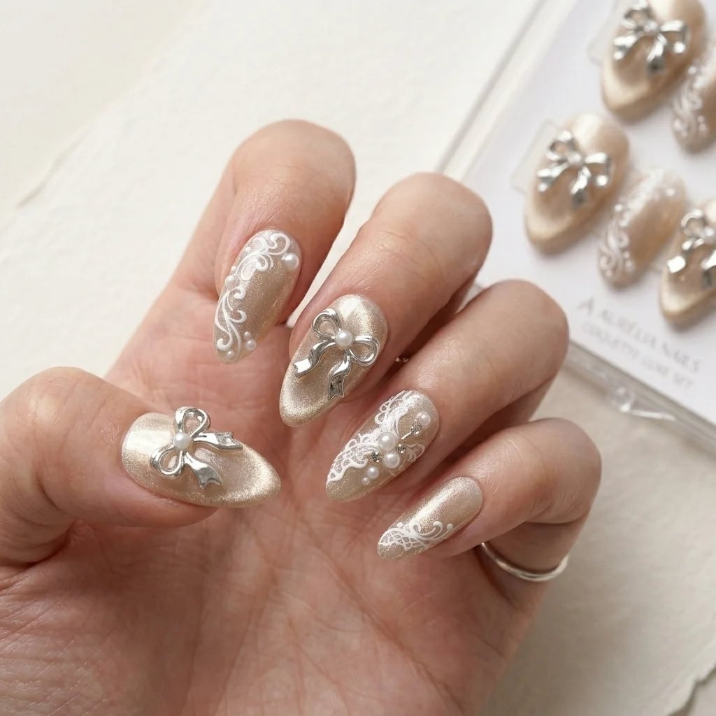 Medium Almond Champagne with Lace, Silver Bows, and Pearls — Coquette Nails