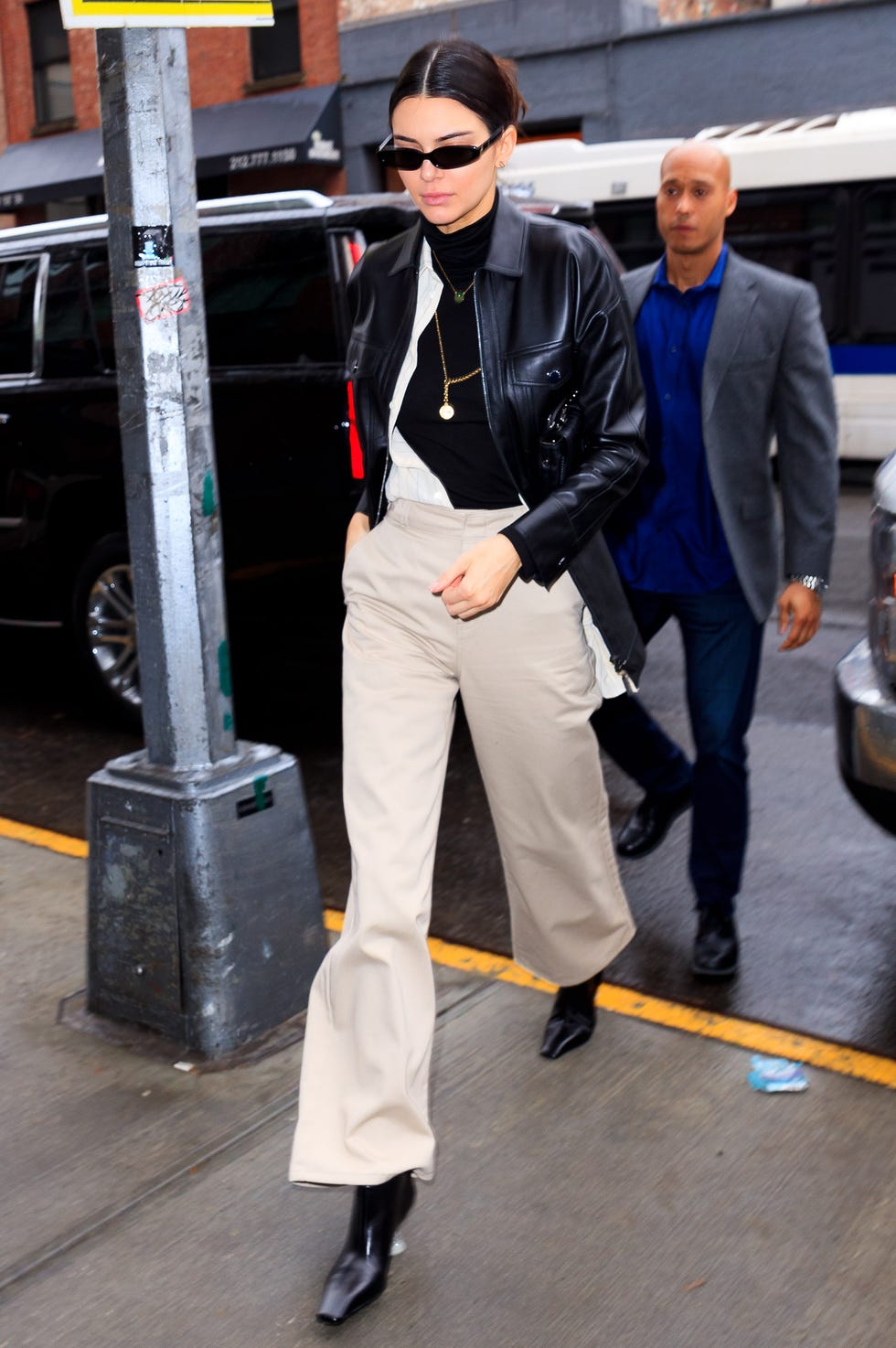 Black Oversized Leather Cropped Jacket With Beige Wide-Leg Pants — Cropped Jacket Outfits