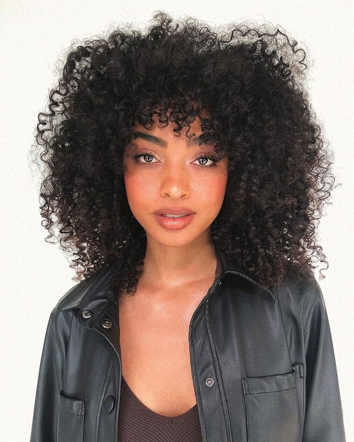 Mid-Back Voluminous Black Hair With Curly Bangs