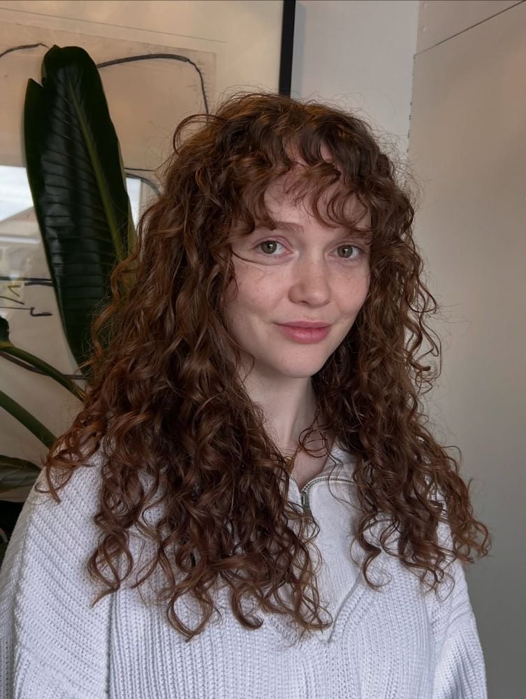 Mid-Back Auburn Curly Hair With Wispy Bangs — Curly Bangs
