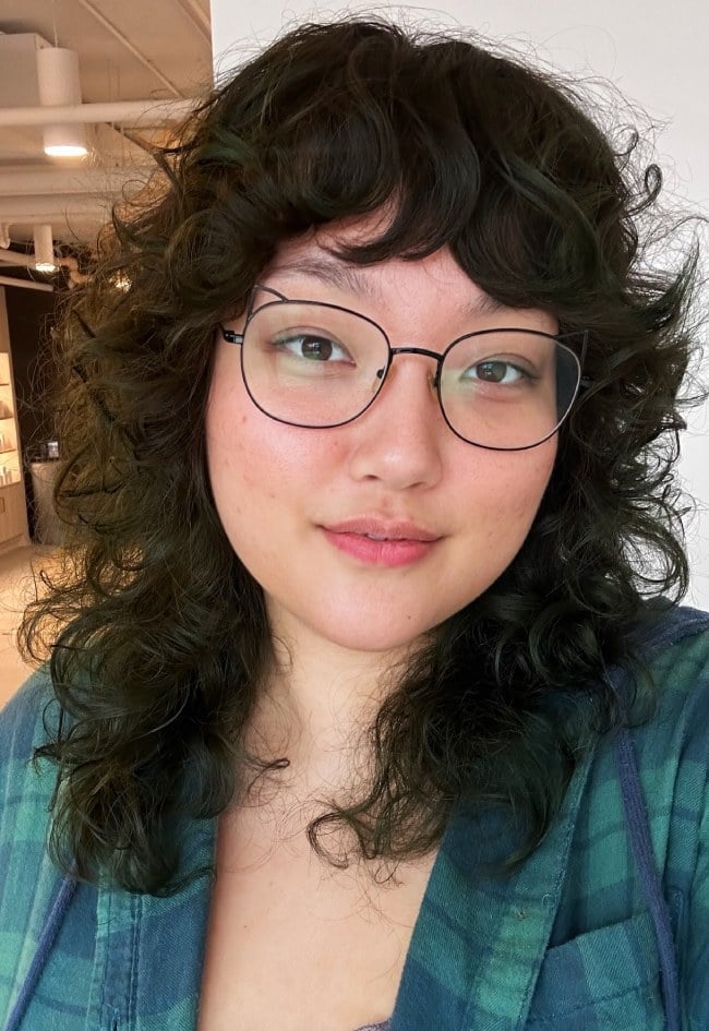 Mid-Back Curly Shag With Copper Highlights and Curtain Bangs