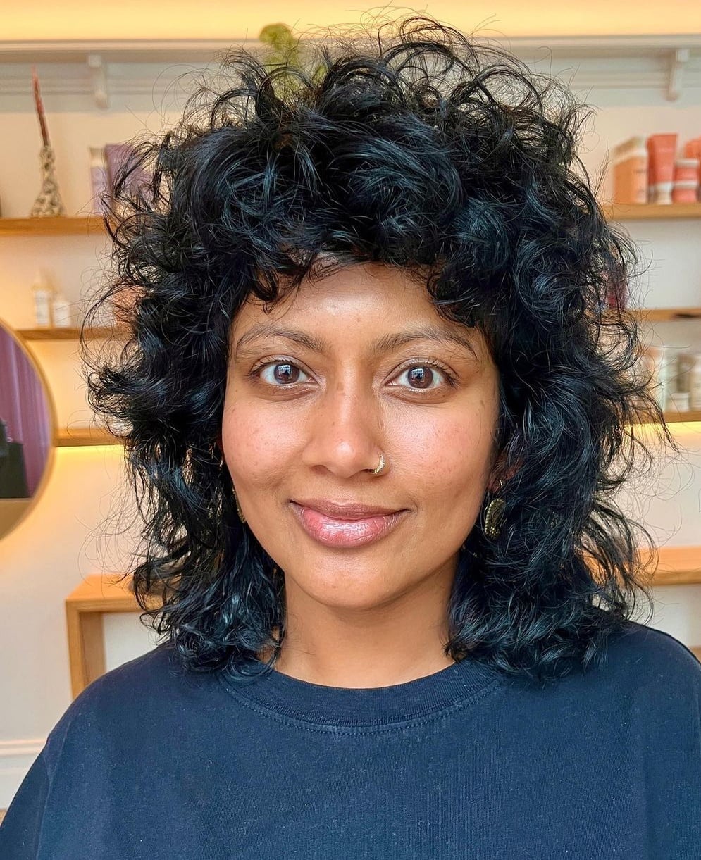 Shoulder Length Black Wolf Cut With Short Curly Bangs — Curly Wolf Cut