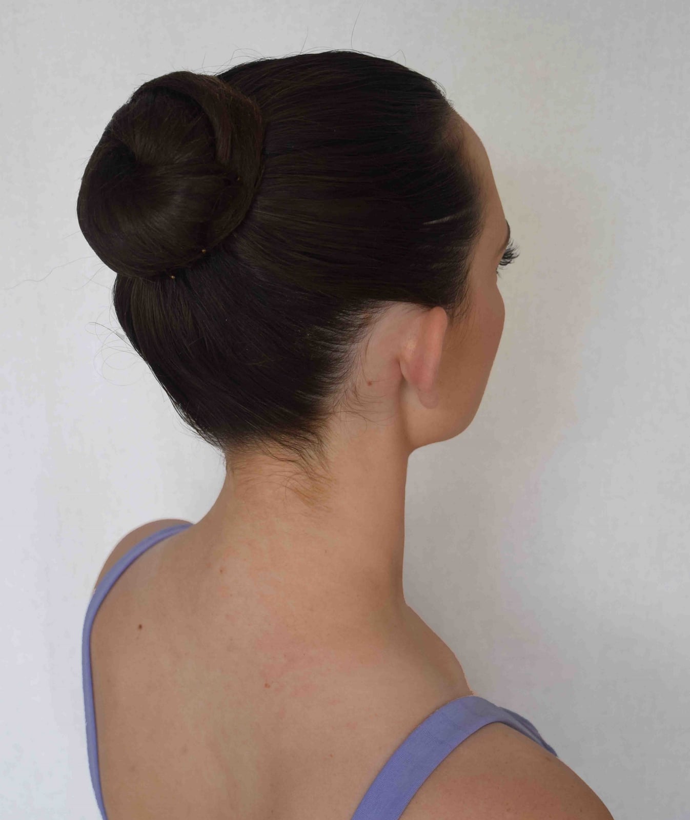 Perfectly Smooth Dark Brown Bun, The Hair Appears Thick And Straight Perfectly Smooth Dark Brown Bun, The Hair Appears Thick And Straight — Dance Hairstyles