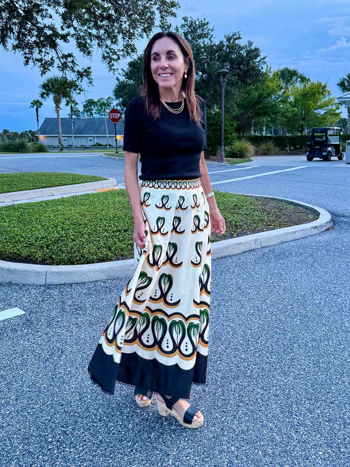 Black Top with Printed Cream Maxi Skirt and Gold Necklace — Dinner Outfits Classy