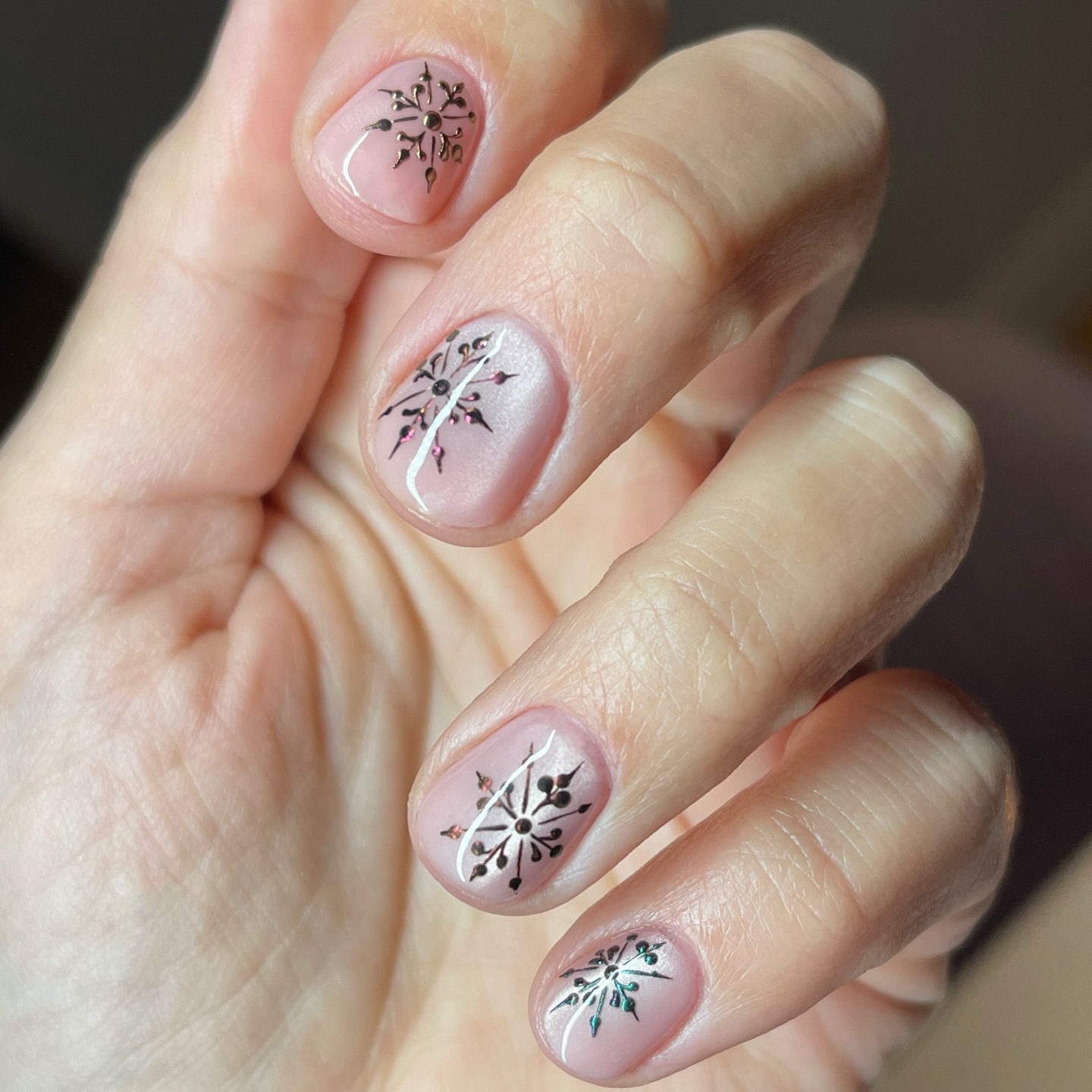 Elegant Snowflake Nail Art with Rose Gold Accents