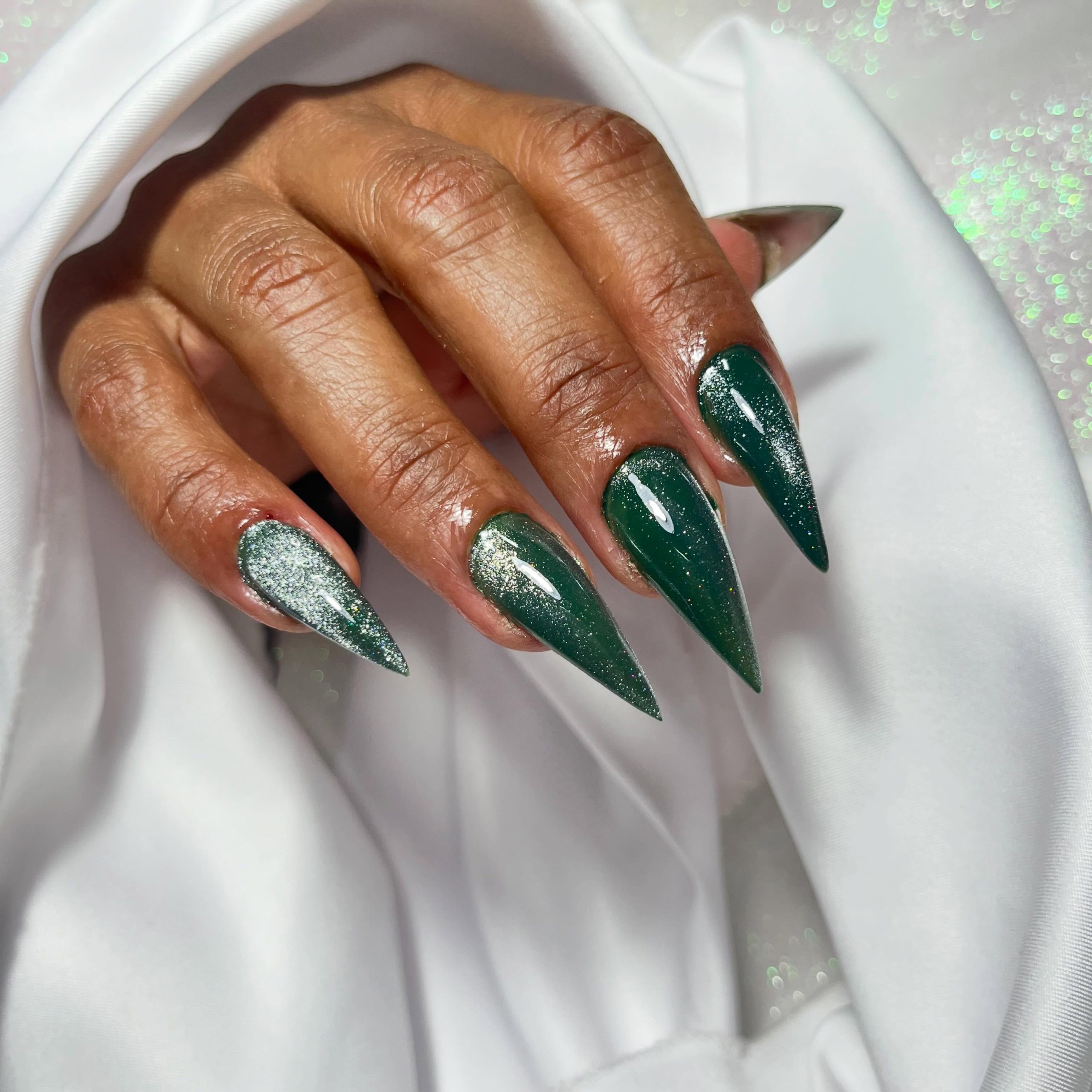 Emerald Cat Eye Stiletto Nails with Glitter Accents