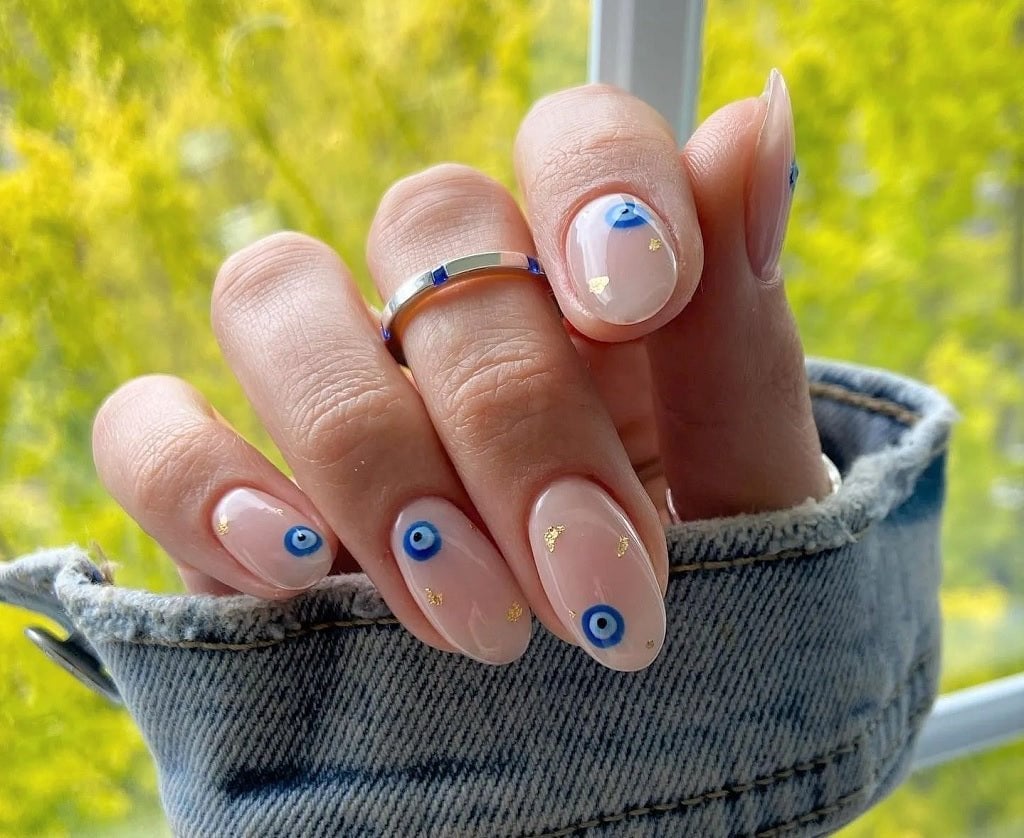 Sheer Nude Oval Nails With Blue Evil Eyes Sheer Nude Oval Nails With Blue Evil Eyes — Evil Eye Nails