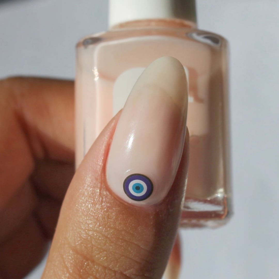 Milky Pink Nails With Tiny Evil Eye Decal Milky Pink Nails With Tiny Evil Eye Decal — Evil Eye Nails