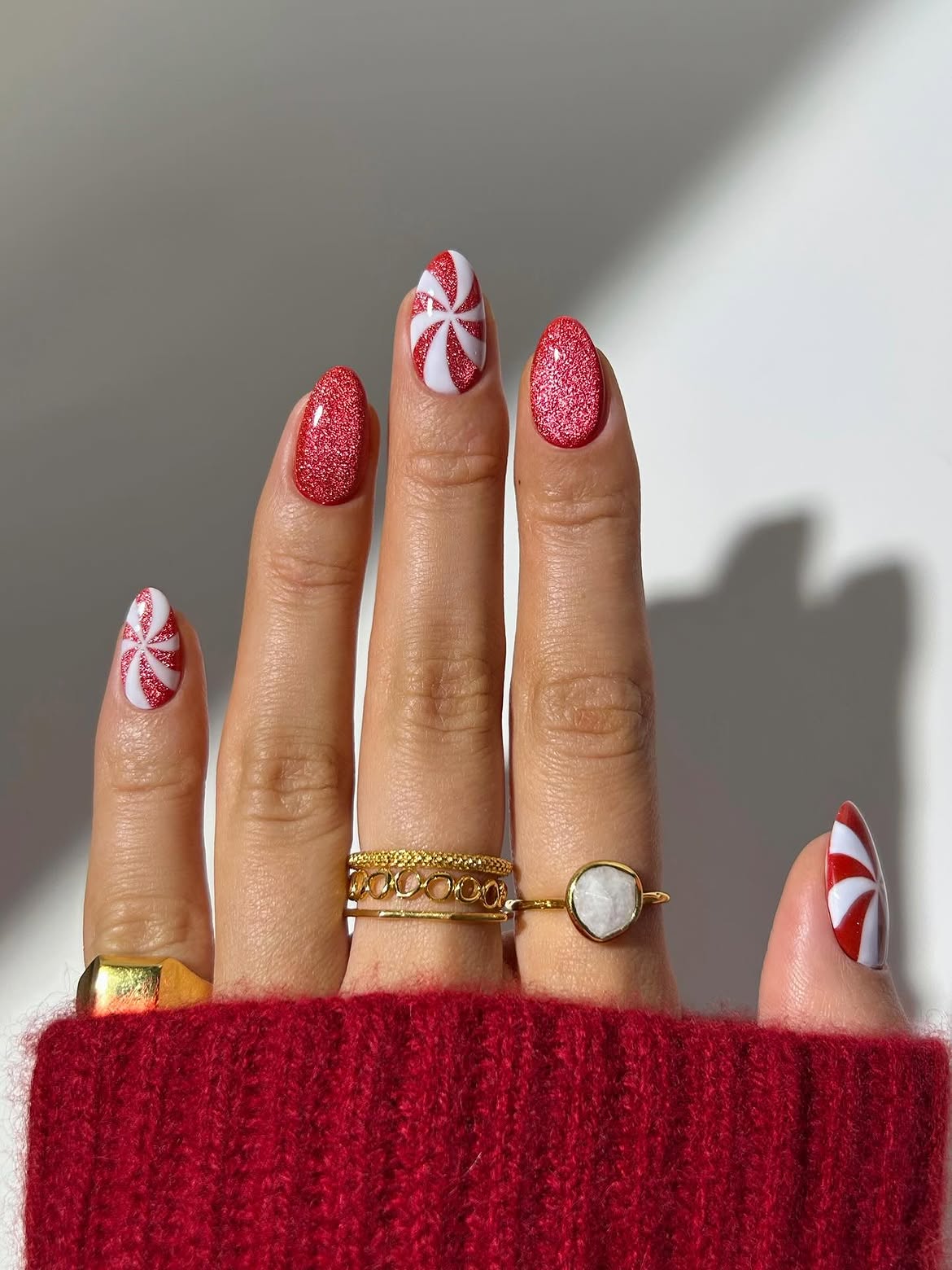 Festive Peppermint Swirl Almond Nails With Red Glitter