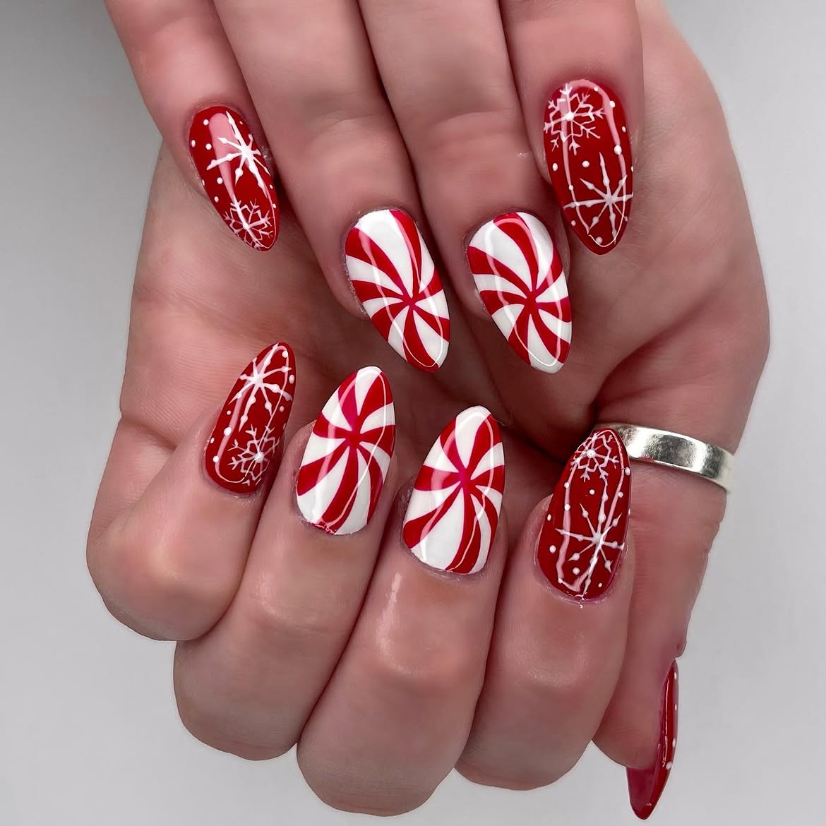 Festive Peppermint Swirl And Snowflake Almond Nails