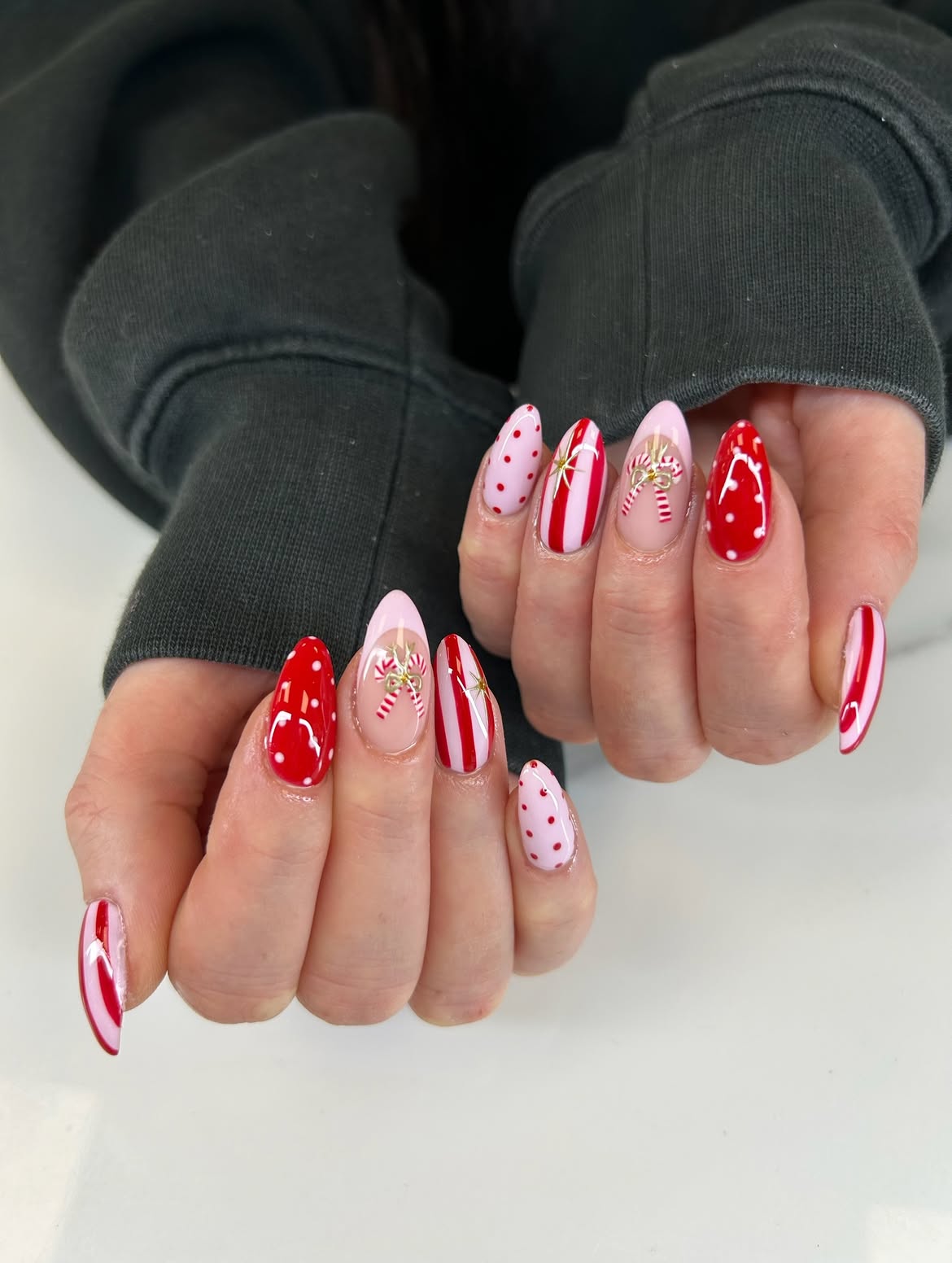Festive Red And Pink Candy Cane Almond Nails