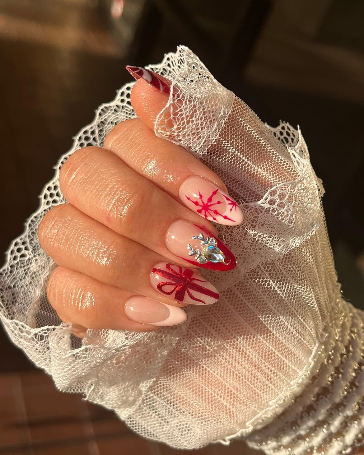 Festive Red Bow and Snowflake Almond Nails