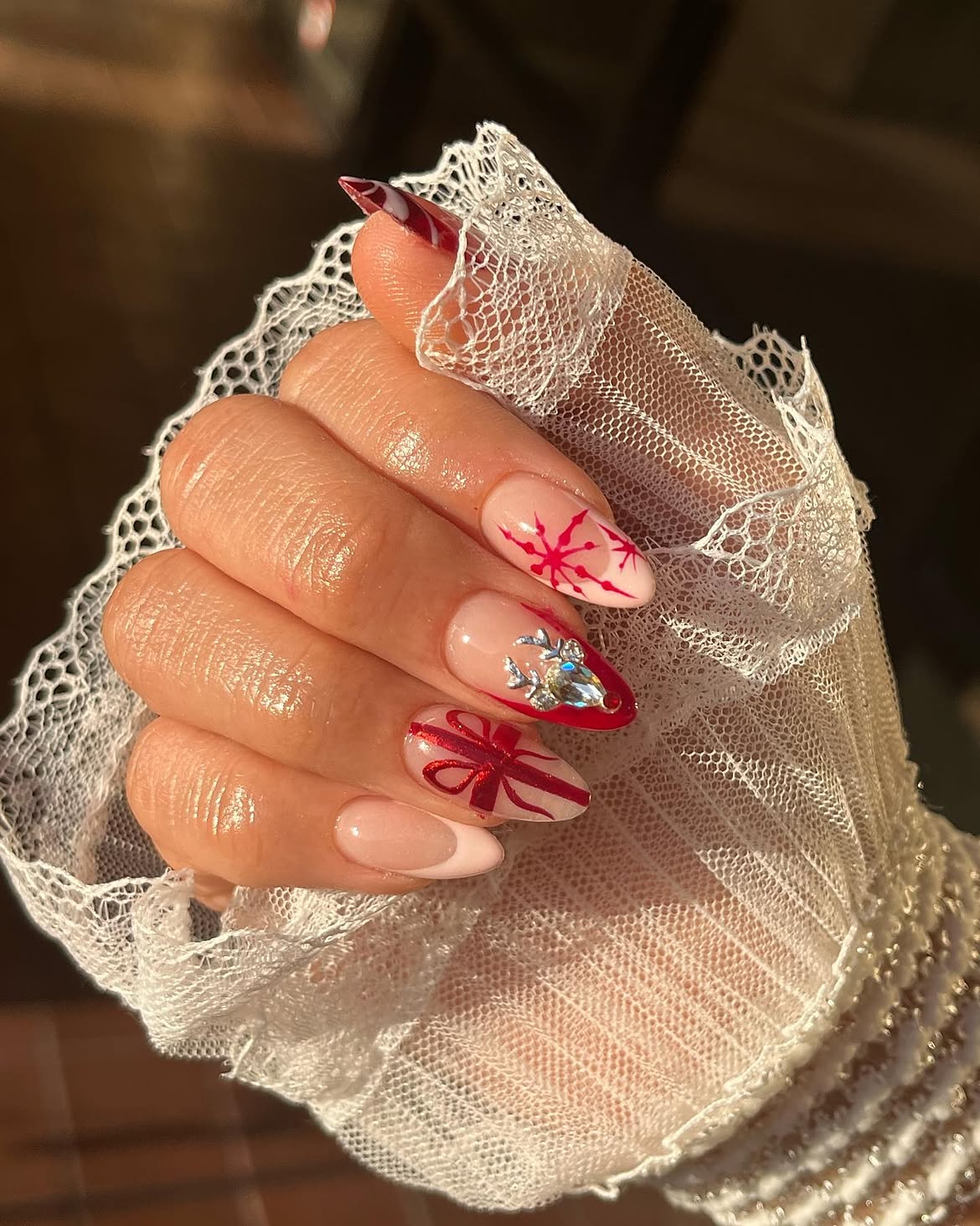 Festive Red Bow And Snowflake Almond Nails