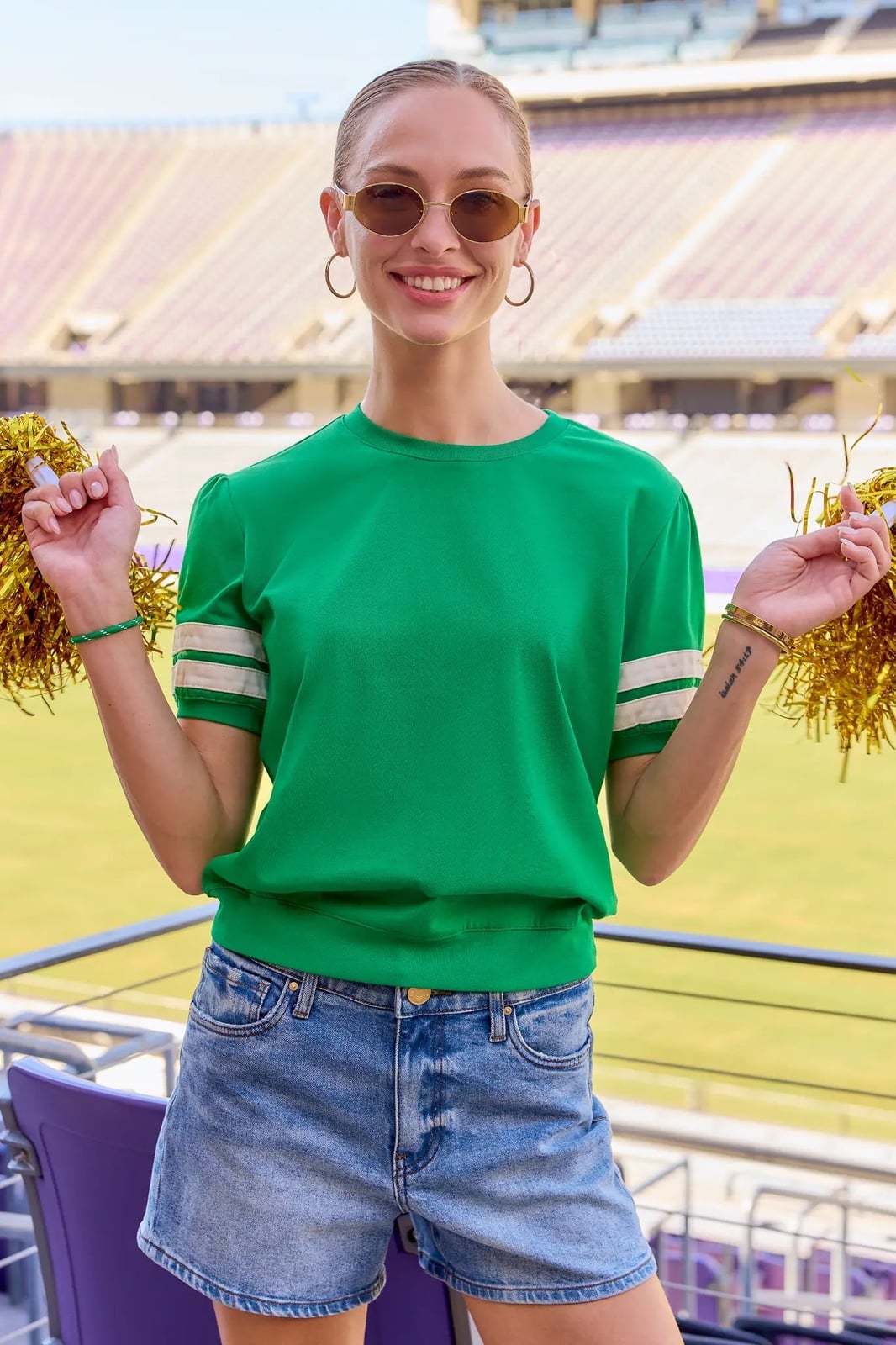 Green Top with Striped Cuffs and Denim Shorts, Close-Up Take — Game Day Outfits