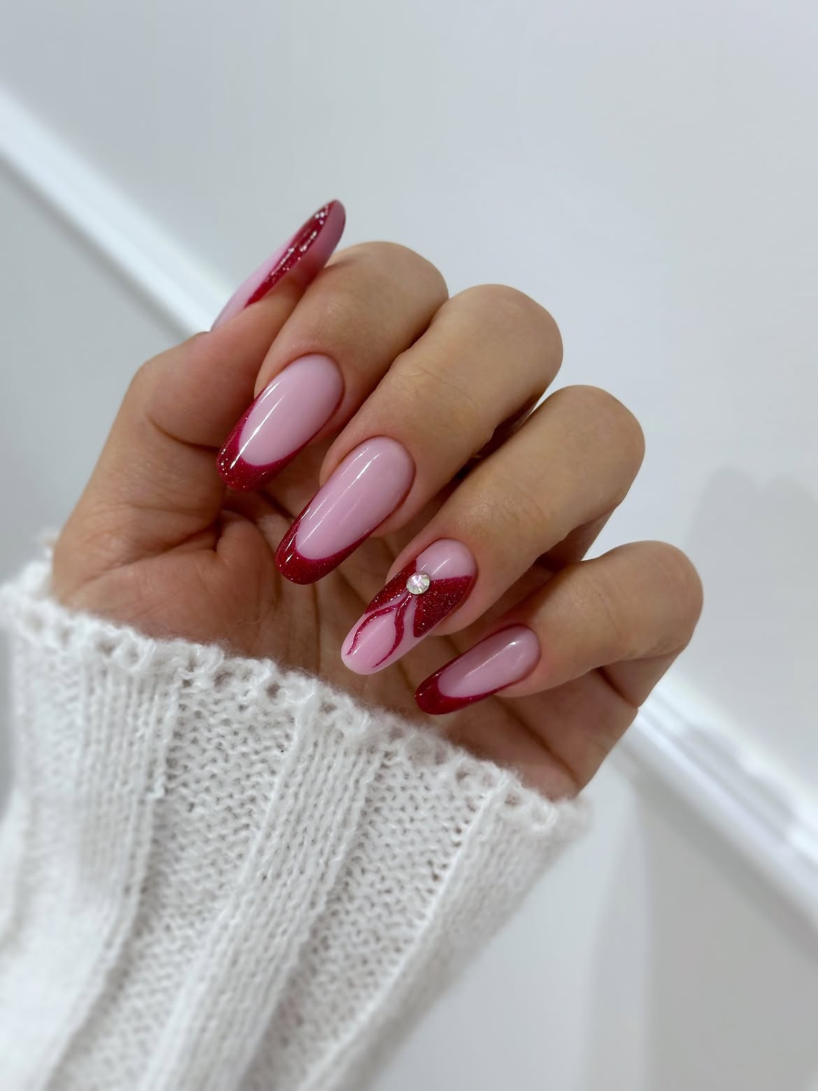 Glittering Red French Tip Almond Nails