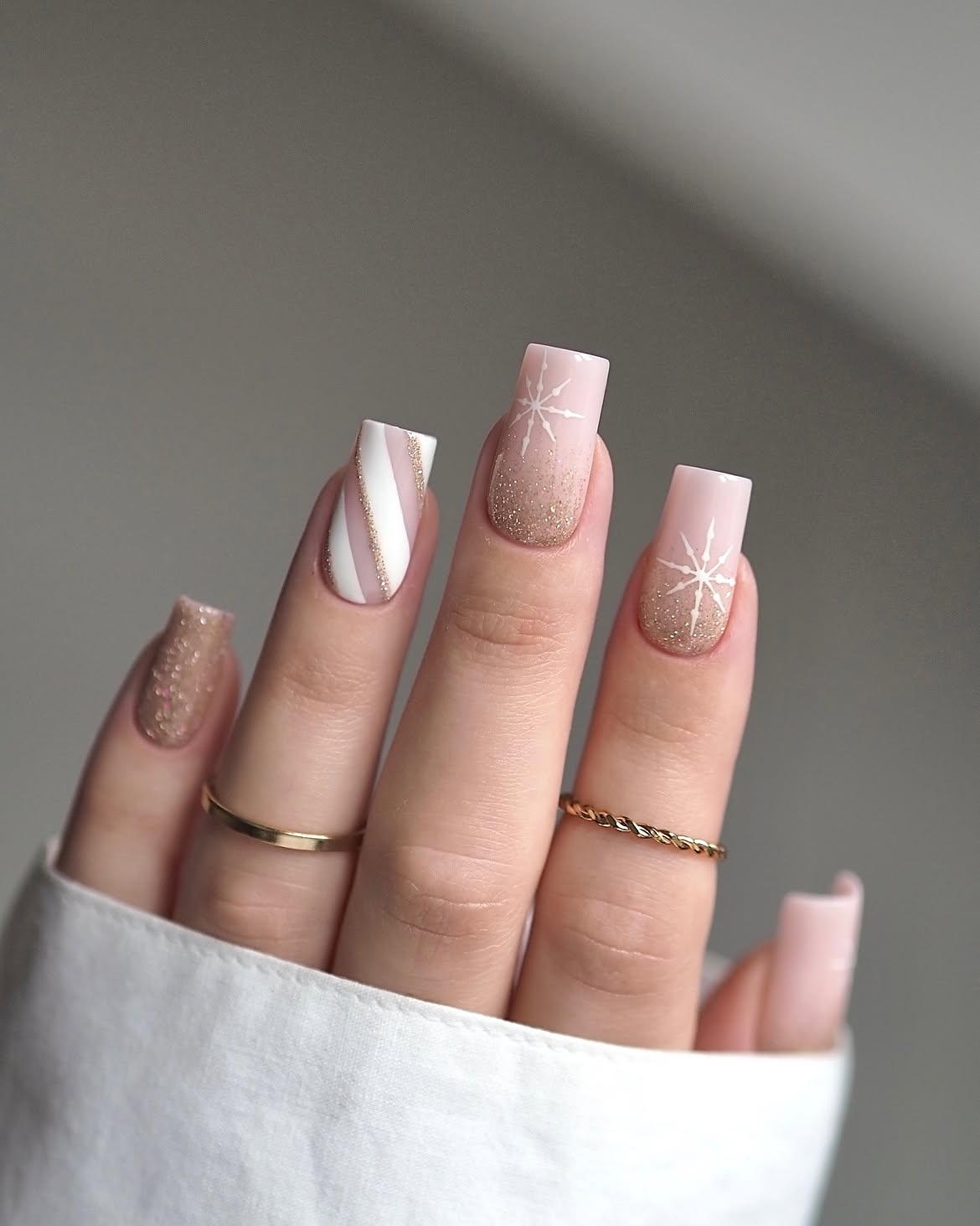 Glossy Nude Square Nails With Gold Glitter And Snowflakes