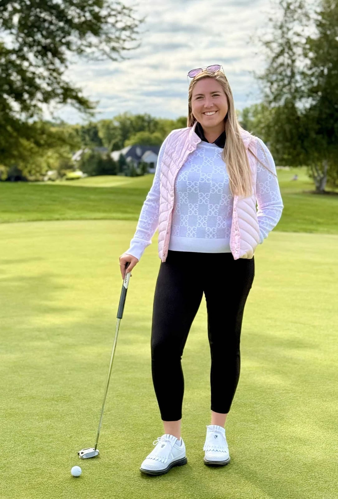 Pink Puffer Vest Over White Sweater and Black Shirt — Golf Outfits
