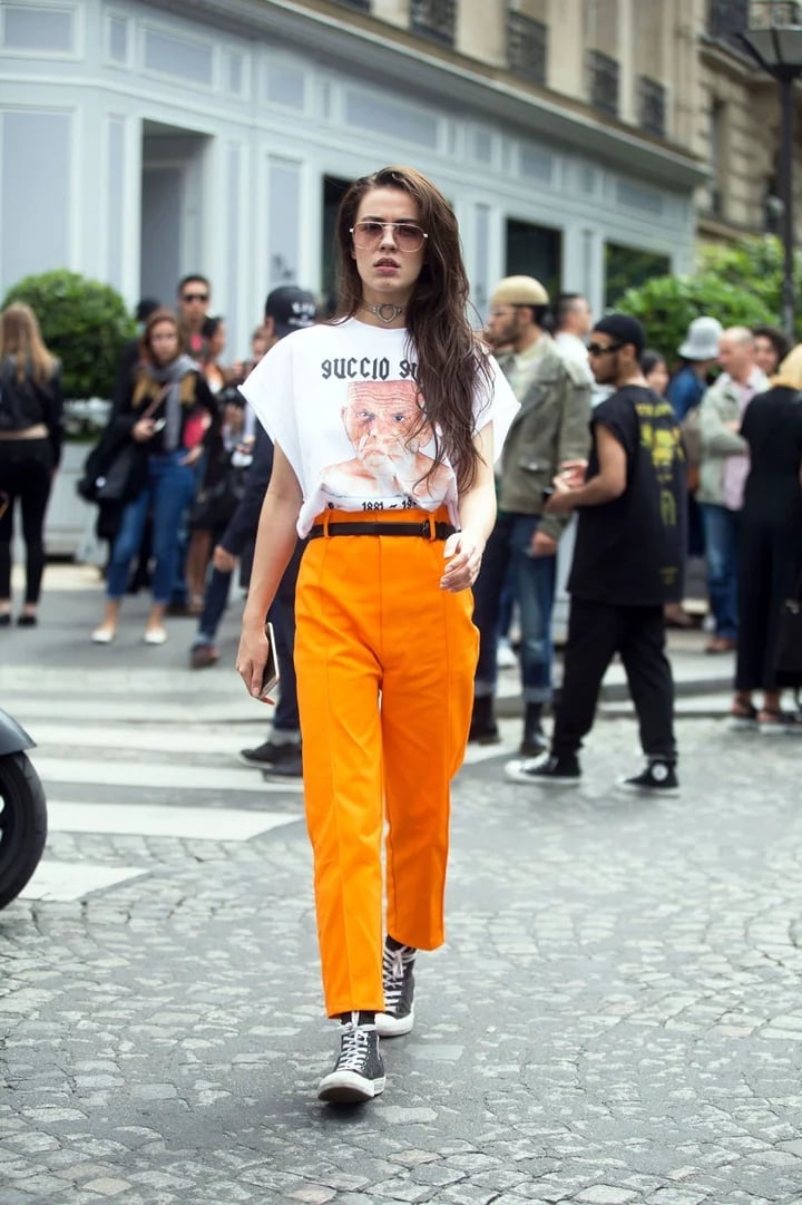 Oversized Graphic Tee Tucked into Bright Orange Trousers — Graphic Tee Outfits