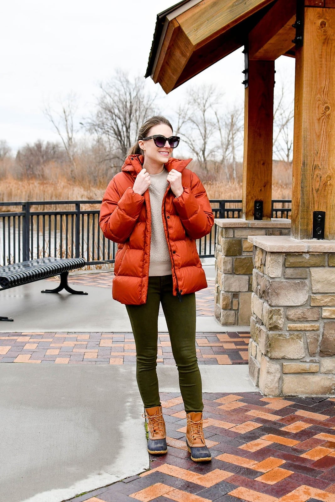 Olive Green Skinny Jeans With Puffer Jacket and Cream Knit Sweater — Green Jeans Outfits