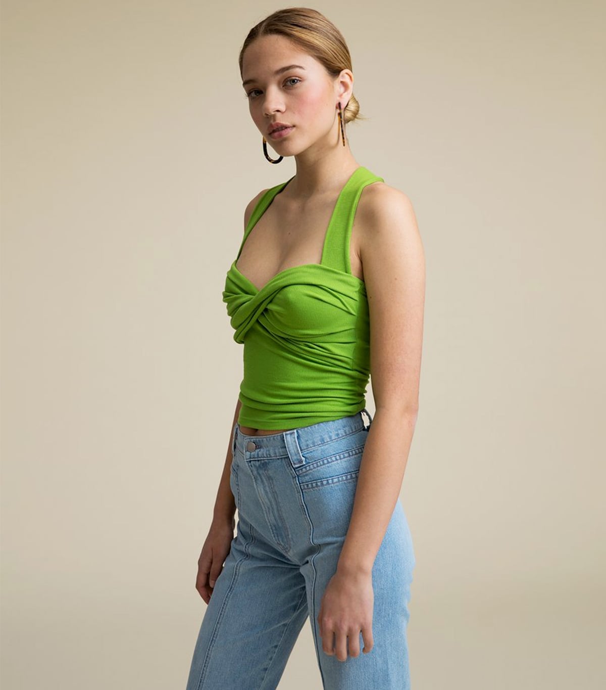 Lime Green Knit Top With Twisted Bust Detail and Dark Hoop Earrings — Green Top Outfits