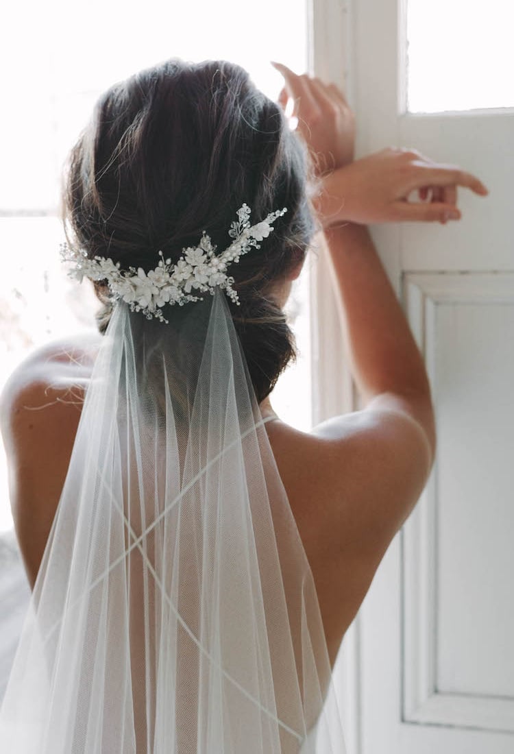 Dark Brown Sleek Low Bun With Veil and Floral Accessory Dark Brown Sleek Low Bun With Veil and Floral Accessory — Hairstyles for Wedding
