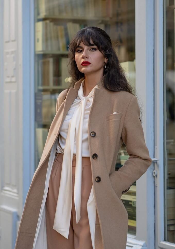 Camel Coat Over Cream Blouse and Tan Trousers Camel Coat Over Cream Blouse and Tan Trousers — Layered Ideas