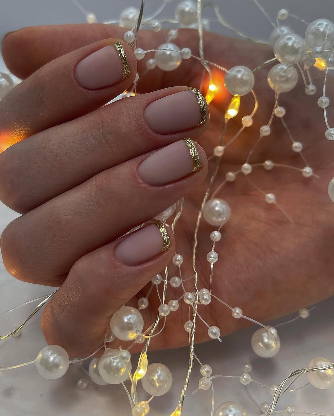 Matte Nude French Tips with Gold Glitter Accents
