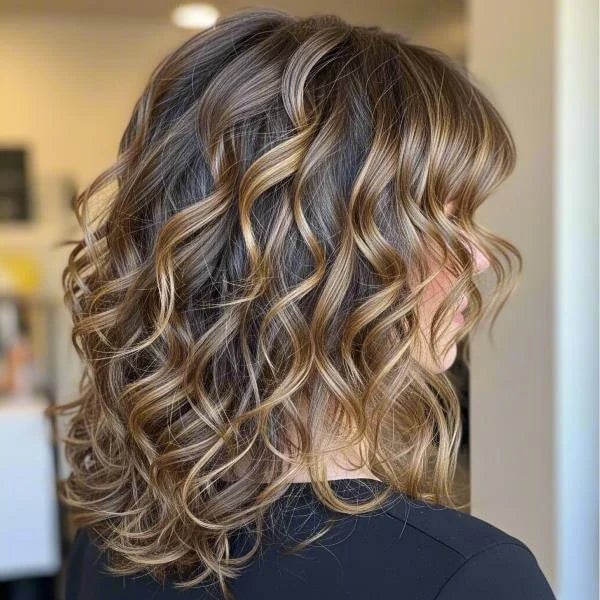 Collarbone Layers With Blonde Highlights — Medium Curly Hair