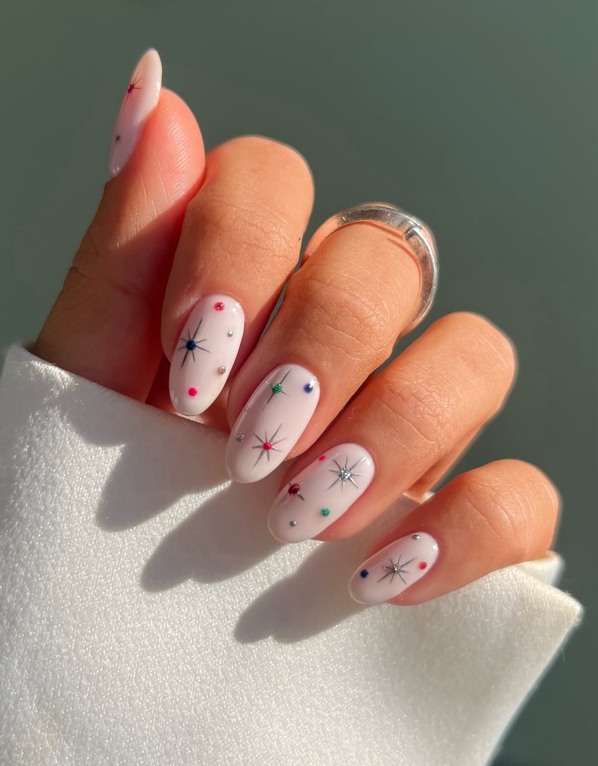 Milky White Almond Nails With Festive Stars And Crystals