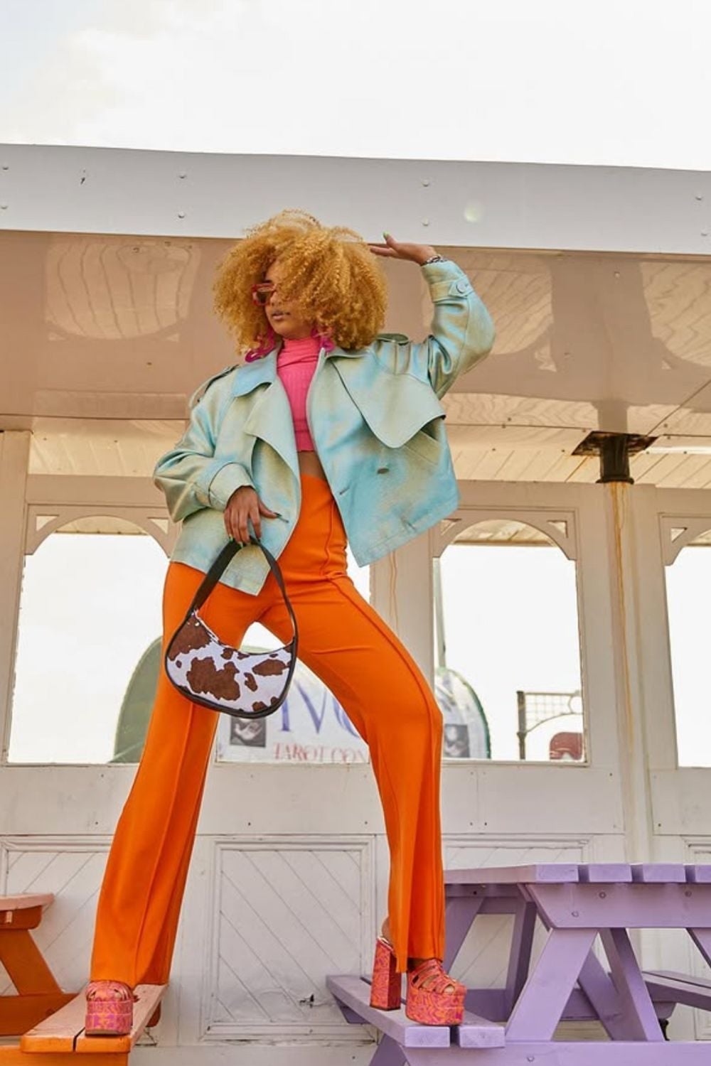 Bright Orange Flare Pants With Tie-Dye Jacket and Cow Print Handbag — Orange Pants Outfits