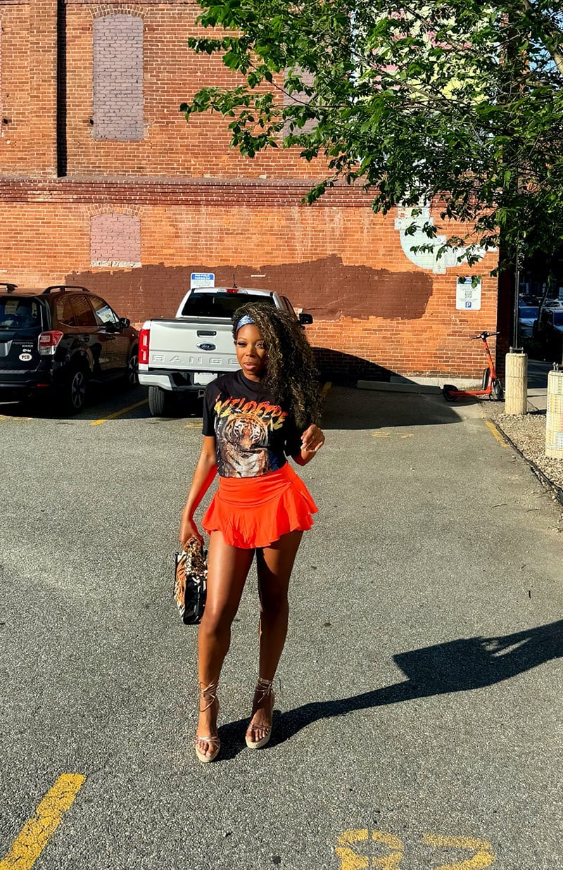 Black Graphic T-Shirt and Orange Flared Mini Skirt Black Graphic T-Shirt and Orange Flared Mini Skirt — Party Outfits Black Women