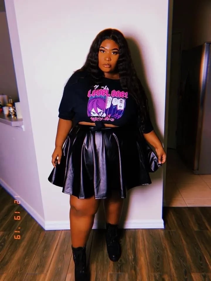Black Graphic T-Shirt Tied at Waist Over Faux Leather Skirt Black Graphic T-Shirt Tied at Waist Over Faux Leather Skirt — Party Outfits Black Women