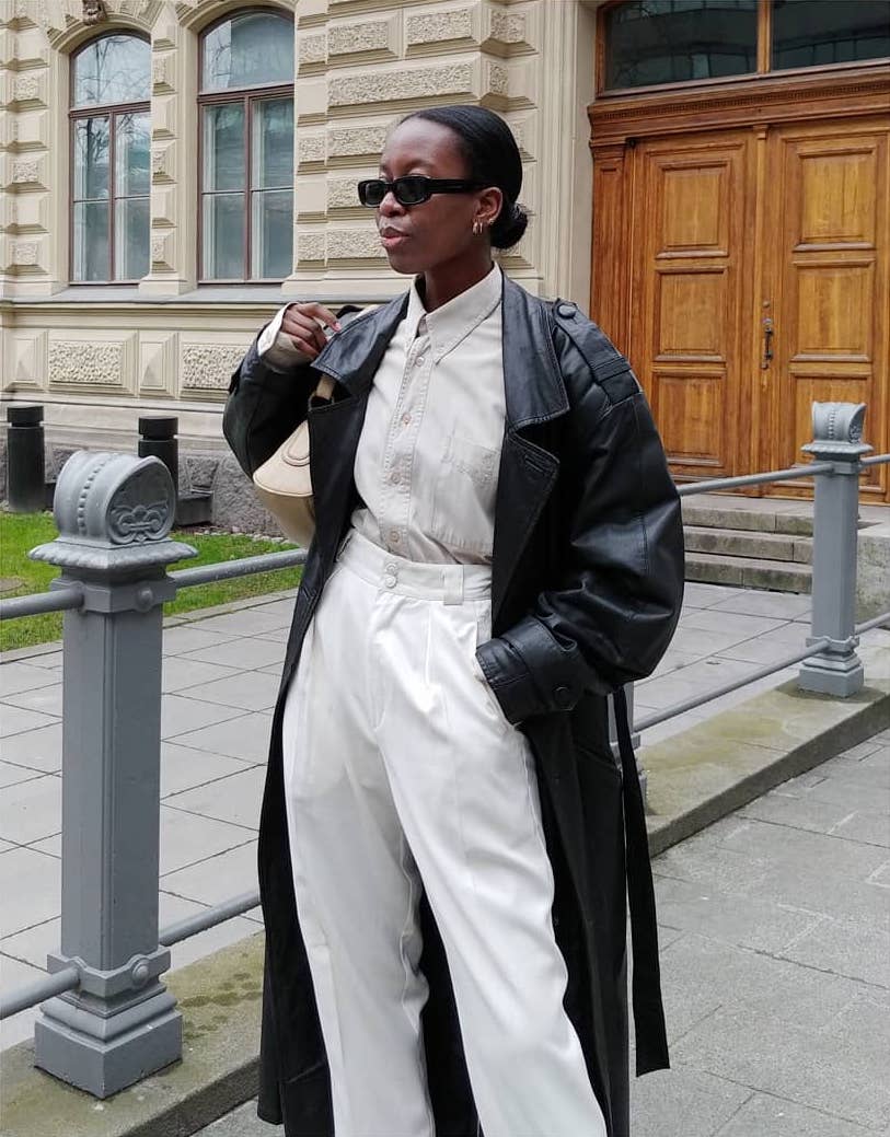 Black Leather Trench Coat Over Cream Shirt and White Trousers — Photo Outfit