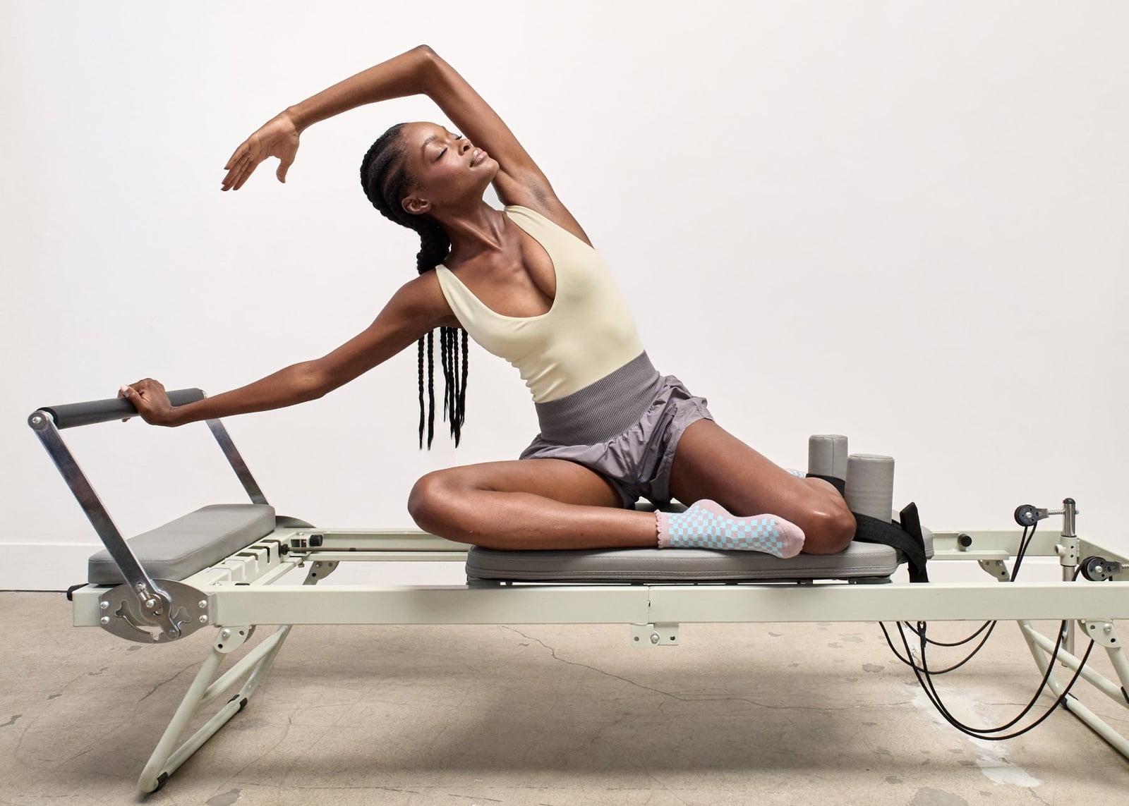 Pale Yellow Bodysuit With Satin Shorts and Checkered Socks — Pilates Outfits