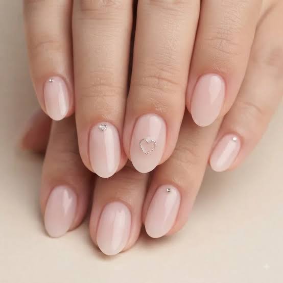 Sheer Pale Pink Almond Nails with Silver Studs and Hearts