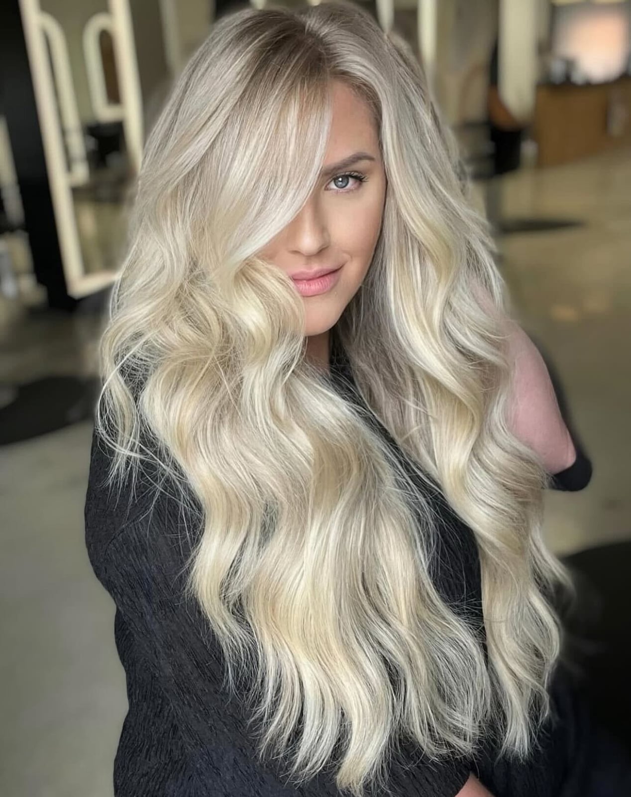 Voluminous Platinum Blonde Waves With Curtain Bangs Voluminous Platinum Blonde Waves With Curtain Bangs